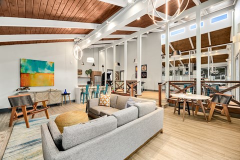 a living room with a couch and tables and chairs